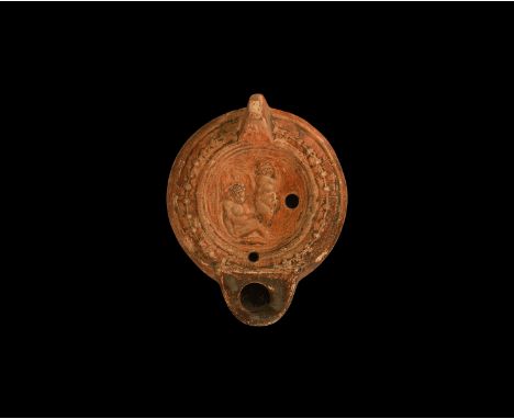 19th century AD. An antique or earlier Roman ceramic oil lamp in 3rd century AD style with round flat nozzle, lug handle to t