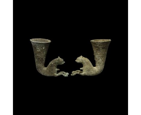 A matched pair of undated archaistic bronze rhytons, each with flared cup and animal finial with extended forelegs.  2383 gra