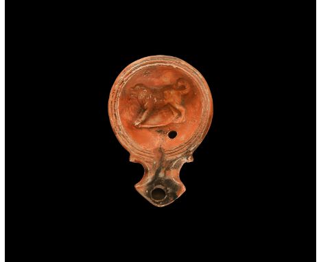 19th century AD. An antique or earlier Roman ceramic oil lamp in 1st century AD style with triangular nozzle, volute scroll t