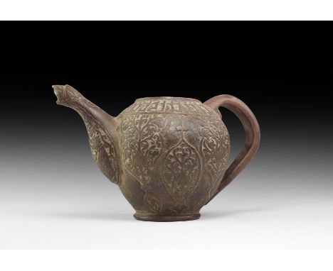 An undated archaistic ceramic spouted pot with loop handle to the rear, band of Kufic text to the shoulder, arabesque panels 
