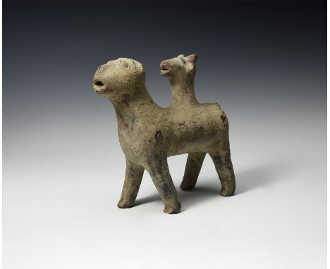 An undated archaistic ceramic figure of a standing canine with a second head emerging from its back.  947 grams, 19cm (7 1/2"