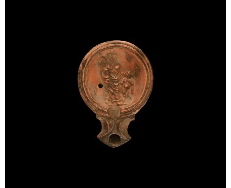19th century AD. An antique or earlier Roman ceramic oil lamp in 1st century AD style with angled nozzle, volute scroll to ea