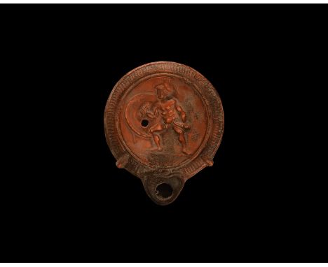 19th century AD. An antique or earlier Roman ceramic oil lamp in 2nd century AD style with round nozzle; the rim decorated wi