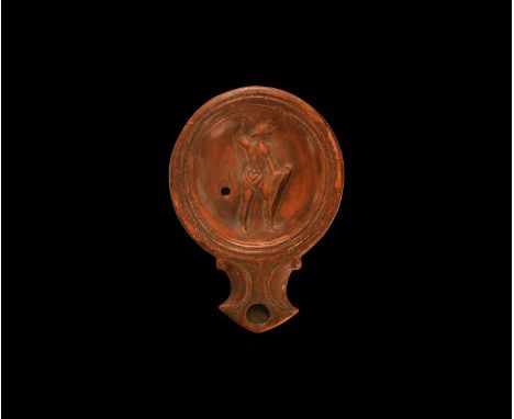 19th century AD. An antique or earlier Roman ceramic oil lamp in 1st century AD style with wide angled nozzle, volute scroll 