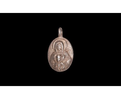 17th-19th century AD. A silver oval pendant with high relief image of the Virgin Mary wearing long robes and with nimbus to t