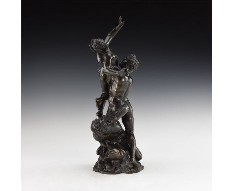 19th century AD. A hollow-formed bronze figural group depicting a nude bearded male crouching beneath a similar figure holdin