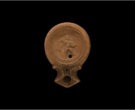 19th century AD. An antique or earlier Roman ceramic oil lamp in 1st century AD style with wide angled nozzle, volute scroll 