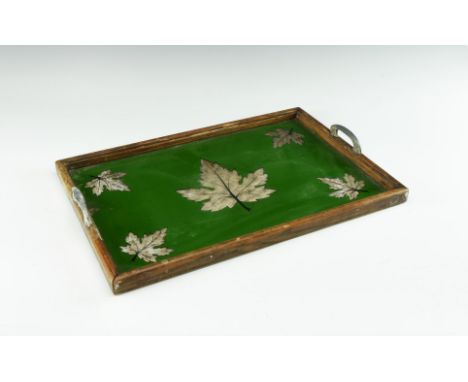 20th century AD. A wooden-framed tray with bracket handles, glass floor with green field and reserved maple-leaf motifs revea