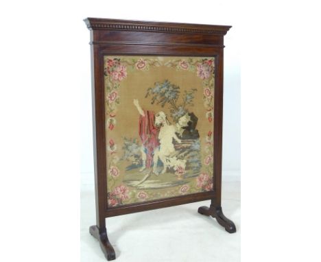 A late 19th or early 20th century glazed firescreen with needle pointed embroidered panel, 65 by 29 by 92cm high.