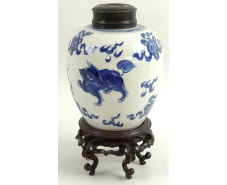 A Chinese porcelain ginger jar, 18th / 19th century, decorated in Kangxi style with three kylin amongst clouds, with cobalt b