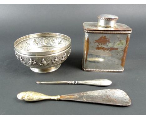 An Indian silver bowl, raised on a foot with a band of sixteen repousse, engraved female deities enclosed in circles, A Bhiga