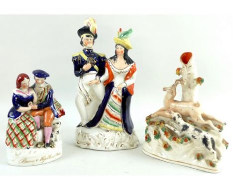 A collection of three Victorian Staffordshire flatbacks, one modelled as a lady and gentleman holding hands and ornately dres