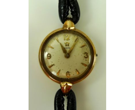 A 9ct gold cased vintage Omega lady's wristwatch, circular champagne dial with Arabic numerals and arrow batons, mechanical 1