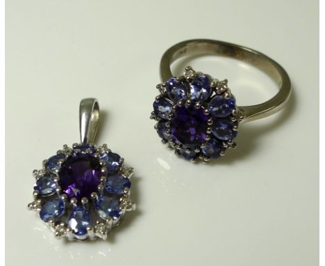 A 14ct white gold, tanzanite and amethyst dress ring with matching pendant, each featuring a central oval cut amethyst of app