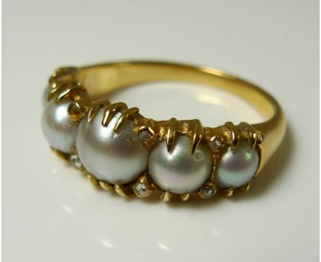 A Victorian 18ct gold and seed pearl ring, the five claw set pearls interspersed with diamond chips, a/f one missing, largest