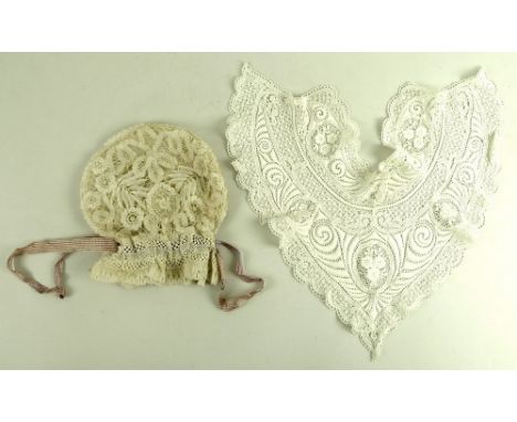 A 19th century Honiton bobbin lace bag, with tape tie, the shaped design having open work of fern leaves to a central oval fl
