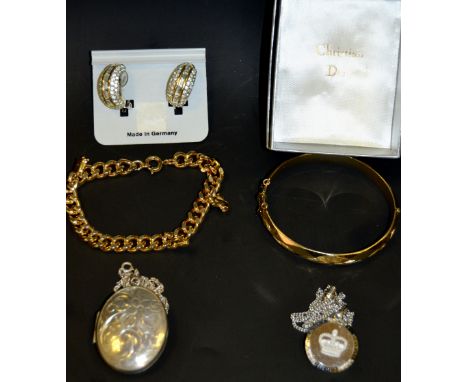 A silver locket; a rolled gold hinged bangle;etc