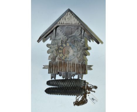 A Black Forest style cuckoo clock, pine cone cast weights  