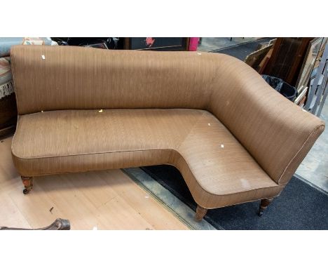 A reproduction Victorian style corner sofa, on plastic casters with brown ground upholstery