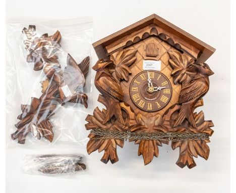 Cuckoo wall clock. German-made modern cuckoo clock. 2 train movement stamped made in Germany. Stained mahogany case with bird