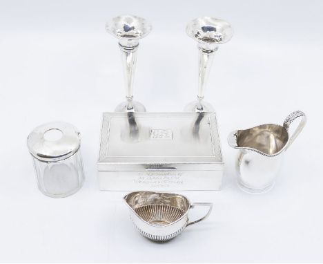 A collection of silver to include: rectangular engine turned cigarette case; two various small cream jugs, a pair of trumpet 