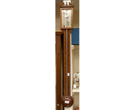 A modern reproduction style mahogany stick barometer