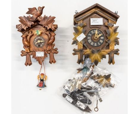 Two Cuckoo clocks in Black Forest style. (1) A German cuckoo clock with 2 bellows, German movement striking on a gong. 6cm di
