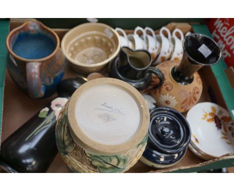 A collection of eartheware and ceramics to include: Ault Swadlincote vase decorated with a flower; Denby GPO jug, Bourne jug 