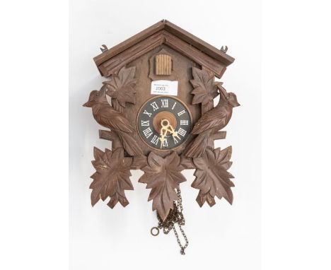 A modern German-made cuckoo clock. Black Forest-style birds on front of case. 3 inch dial. Case 11ins high x 9 ins x 5 ins de