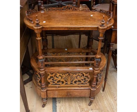 A Victorian walnut Canterbury, having turned legs on original castors, top galleried shelf with turned finials, single drawer