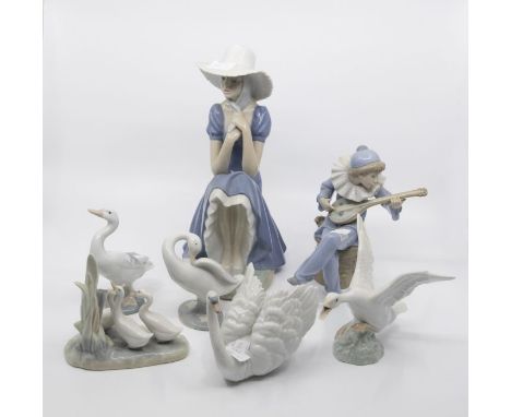 A group of Lladro and Nao figures to include boy playing instrument, geese, lady tying bonnet, swan etc.