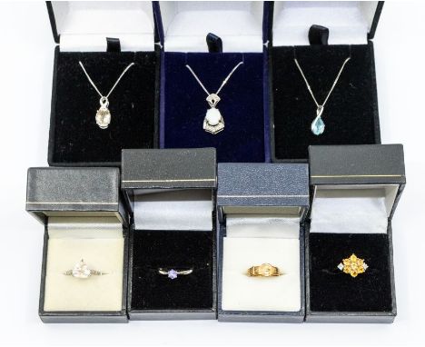 A collection of 9ct gold jewellery to include three 9ct white gold pendants one set opal and diamond, one set blue topaz, one