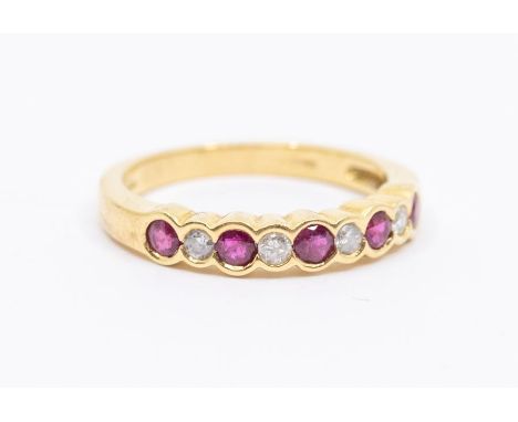 A ruby and diamond 18ct gold half eternity ring, rub over set with alternate round cut rubies and brilliant cut diamonds, siz