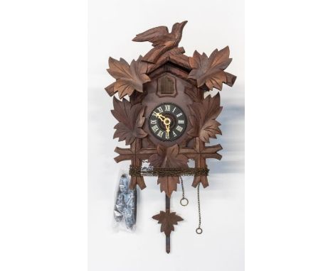 Cuckoo clock. West German cuckoo clock in Black Forest style. 3 inch dial. Weights, pendulum and pediment present.Condition r