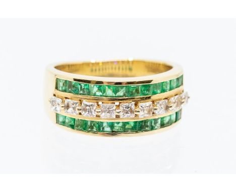 An emerald and white stone three row 14ct gold ring, comprising a single row of French cut white stones, possibly white sapph