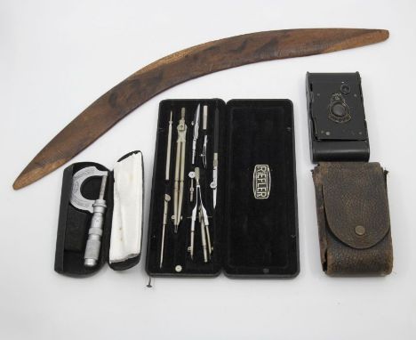 Pair of brass candlesticks, WWII Tunick cased camera, case engineering tools and boomerang