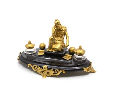 A late 19th century slate desk stand, with pen tray and two cut-glass inkwells, mounted with a gilt figure of Archimedes, wit