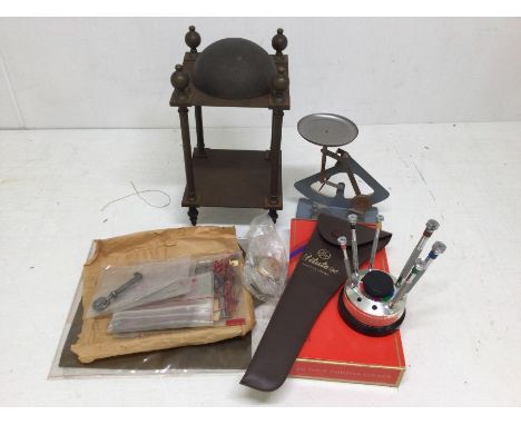 A collection of watch and clock makers tools including scales, along with parts of a Lantern clock with brass body