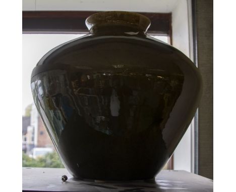 Studio Pottery: A large green glazed planter of ovoid form. Diameter approx 32cm, height approx 31cm. Crazing to the glaze.