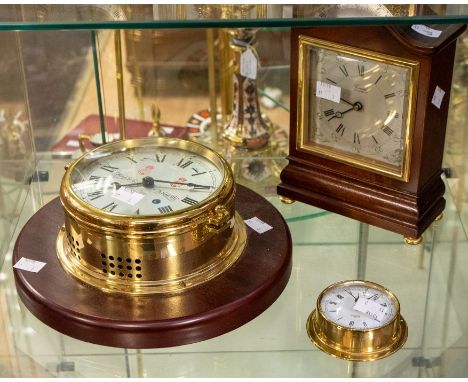 A modern Sewills ship's clock, mounted together with a smaller Barigo ships clock and a modern Comitti of London cased mantle