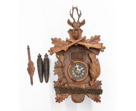 A modern German Black Forest cuckoo clock on 2 trains, with cuckoo and man in traditional German dress. 6cm dial. Carvings of