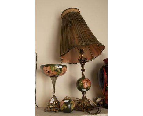 A collection of Moorcroft Pottery to include 3 pieces of green background hibiscus lamp with shade, a table lighter and a bow
