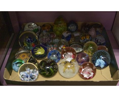 A collection of glass paperweights to include signed and Caithness