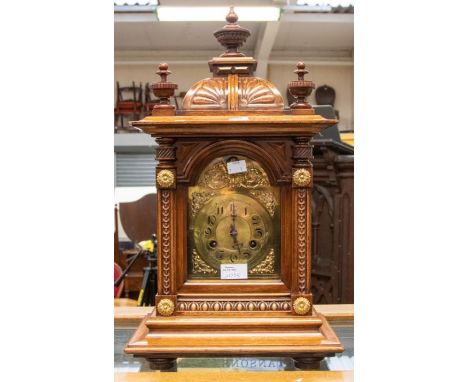 Edwardian mantle clock in oak case, brass dial with Arabic numerals, two train movement, striking on a gong, key and pendulum