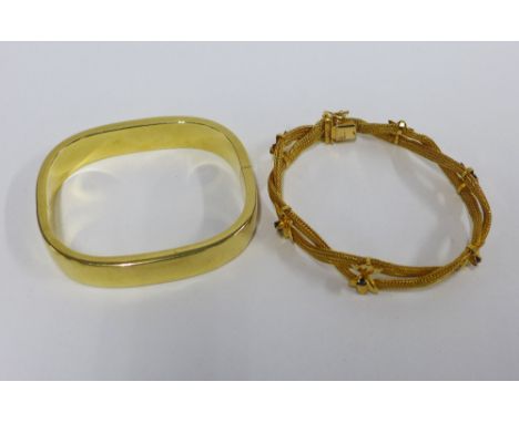 18ct gold bangle of plain rectangular design with hinged clasp, stamped 750, approx 41g, together with an Eastern yellow meta