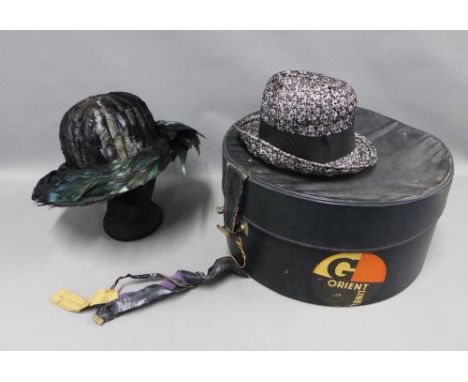Vintage hat box with an Orient Line travel sticker, together with  a hat with iridescent feathers and a black and white hat (