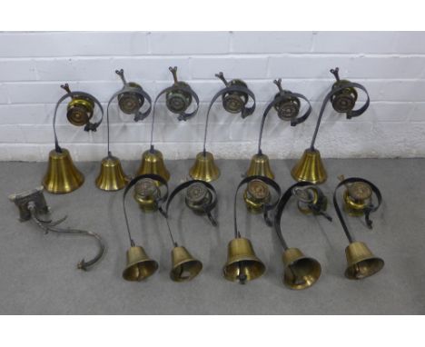Set of eleven brass and black painted metal servants bells together with a wall light (12)