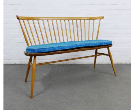 Ercol light elm and beech bench / love seat, designed by Lucian Ercolani, with shaped top rail and stick back, solid shaped s