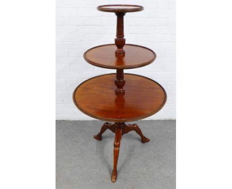 Three tier dumb waiter, each graduating shelf with a gadrooned edge, on a  baluster column with  three jointed legs terminati