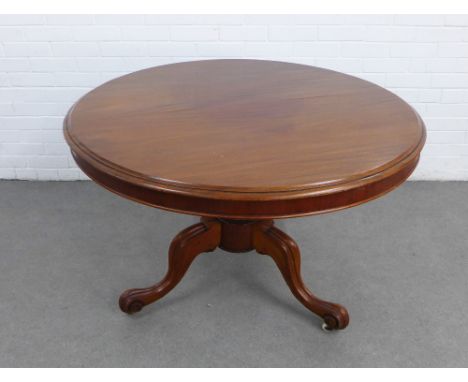 Mahogany tilt top breakfast table, the circular top with a moulded edge, raised on a baluster column with tripod legs termina